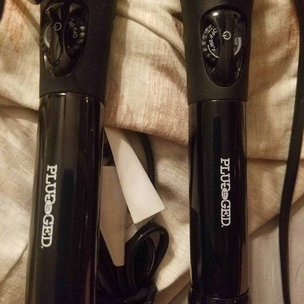 2 plugged in never used curling irons